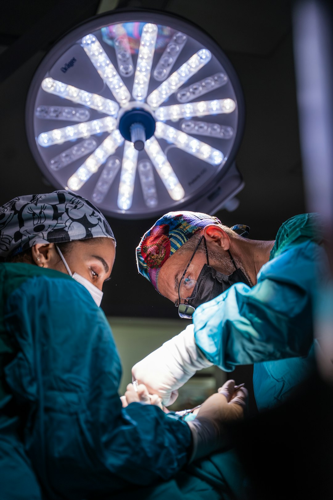 two surgeons performing surgery on a patient in a hospital v 0es17m9tc